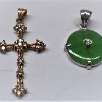 2 x 9ct gold pendants - white round green jade with small dia, to centre in white gold setting & yellow gold filigree cross set with 15 small diamonds - Sold for $75 - 2018