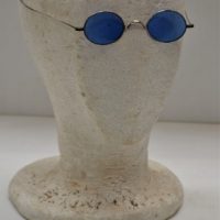 Pair of c1920s small Round lensed Sunglasses w Blue Lenses, in original case - Sold for $50 - 2018