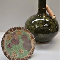 2 x pieces Australian Pottery incl Rynne Tanton plate with crackle glazed edge and large Malcolm Boyd vase with celadon glaze - both with floral decor - Sold for $62 - 2018