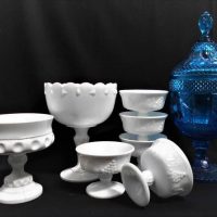 Group of Glass incl Milk glass tureens and desert bowls, and lidded blue glass footed jar - Sold for $37 - 2018