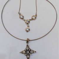 2 x silver necklaces - silver wire collar with large cross set with clear stones & other with four pale blue topaz in rubbed in setting - Sold for $37 - 2018