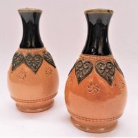Pair of small Royal Doulton Slaters patent stoneware vases with black glazed necks and raised decoration and marks to bases- approx 8cm H - Sold for $50 - 2018