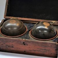 Vintage hinged box with pair of lawn bowls in cups - Sold for $35 - 2018
