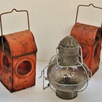3 x vintage carry lamps inc, 2 x red workman's (SEC & ECV) and round glass with wire cage - Sold for $81 - 2018