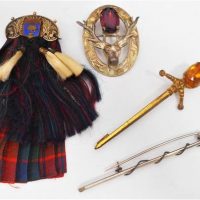 4 x Scottish Brooches silk Sporin, EPNS Stag Head with Thistle pattern inset with amethyst and Broadsword Brooch with Carnelian etc - Sold for $81 - 2018