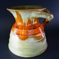 1930s Remued  Australian pottery branch handled  vase - green and brown glaze marked to base-  Remued 232 - 12cm H - Sold for $124 - 2019