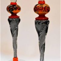 Pair of Signed Modern Art Glass Candlesticks in Burnt orange and red with black basket woven stems - chip to rim on one 40cm H each - Sold for $50 - 2019