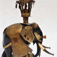 Antique ebony Elephant in Armour with stupa finial and jewelled head plate - Sold for $62 - 2019