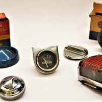 Group of Vintage Fuel tank caps, indicator and dial including boxed Mopar and Boxed Hella tail lamp - Sold for $87 - 2019