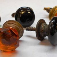 Group of small knobs incl green and amber faceted glass - Sold for $37 - 2019