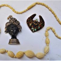 3 x pces Vintage jewellery - 1950s female Blackamoor style brooch,  ivory necklace with graduated beads & 1930s gilt coloured paste brooch - Sold for $43 - 2019