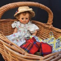 Group lot - basket with 1950s Pedigree hard plastic doll - sleep eyes, open mouth, extra clothing, needs restring - Sold for $112 - 2019