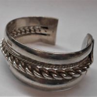 Heavy silver wide bangle with twisted rope design to centre - well marked - Sold for $50 - 2019