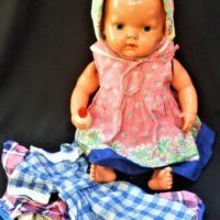 Vintage celluloid baby doll - holding a bottle, with extra clothing, marks to back - 50cms L - Sold for $75 - 2019