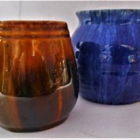 2 x c1930's Australian Pottery - John Campbell incl blue glazed ribbed vase (Loss to glaze on rim) and brown vase with remnants of Tasmanian sticker - Sold for $56 - 2019