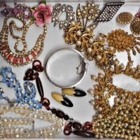 Box lot vintage costume jewellery - Diamante and crystal necklaces, clay beads, porcelain rose brooch, 1950s chunky gilt and pearl necklace, bracelet, - Sold for $37 - 2019