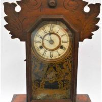 C1900 American New Haven Clock Co Wooden Cottage clock with gilt detailed glass door, 14cm dial and carved decoration to top - approx 58cm H - Sold for $62 - 2019