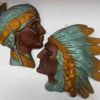 2 x Wall plaques of North American Indian with feather head dress largest dimension 33cm - Sold for $124 - 2019