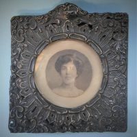 c1905 ornate silver photo frame with pierce work and photo of a lady- approx 16cm x 15cm - Sold for $56 - 2019