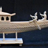Vintage Indian, ornately carved bone boat with figures paddling and peacock bow, (one figure missing), approx 20cm L - Sold for $43 - 2019