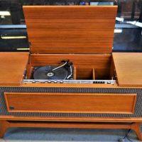 1960s General Electric lowboy Stereogram - Solid State , Garrard turntable, teak veneer cabinet with central storage compartments, approx 151cm L - Sold for $75 - 2019