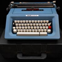 Vintage cased Olivetti 'Studio 46' blue typewriter with cover and manual - Sold for $50 - 2019
