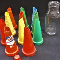 Group lot incl 1 litre NSW glass oil bottle and assorted plastic pourers - Sold for $56 - 2019