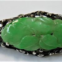 Vintage 192030s silver Brooch with open floral work with carved green jade foliage to centre - Sold for $56 - 2019