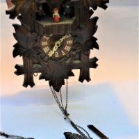 Vintage German wooden Cuckoo clock with ornate carved leaf sign and cuckoo to top - Sold for $50 - 2019