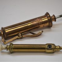 1_2-x-c1800-brass-piston-action-syringes-incl-Arnold-Sons-London-with-ivory-handle-another-with-ivory-nob-Sold-for-161-2019
