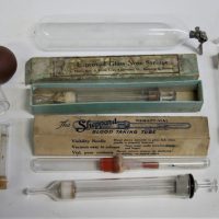 1_Group-lot-vintage-glass-medical-instruments-incl-3-x-glass-nose-syringes-1-with-box-boxed-Sheppard-blood-taking-tube-glass-tube-with-metal-fitting-Sold-for-35-2019