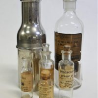 1_Small-lot-vintage-Pharmacy-Apothecary-bottles-most-with-original-paper-labels-inc-Syrup-of-Squill-Ipecacuanha-Wine-one-in-metal-case-etc-Sold-for-75-2019