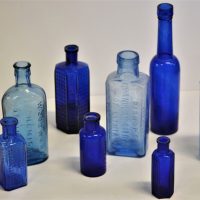 Small-group-lot-vintage-blue-glass-pharmacy-bottles-inc-Woodward-Chemist-Nottingham-Bisurated-Magnesia-by-Bismag-of-London-Bishops-Granular-Citr-Sold-for-43-2019