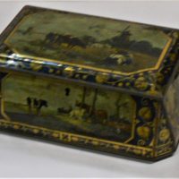 c1900-decorative-casket-shaped-Biscuit-Tin-featuring-gilding-rural-scenes-cows-windmill-boats-farmers-etc-approx-24cms-W-Sold-for-93-2019
