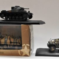 Small-lot-of-3-model-military-vehicles-in-display-cases-inc-tanks-and-halftrack-rocket-launcher-with-German-livery-Sold-for-68-2019