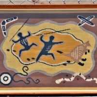 1950s-Kitsch-framed-under-glass-tapestry-Aboriginal-themed-with-2-x-figures-holding-spears-kangaroo-snake-boomerang-etc-approx-40cm-H-58cm-L-Sold-for-56-2020