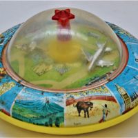 Vintage-battery-operated-kids-tin-toy-UFO-shape-with-images-from-tourist-destinations-from-around-the-world-and-airport-scene-under-clear-central-dome-Sold-for-37-2019