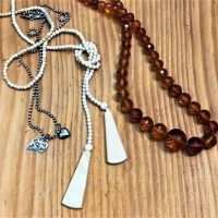 2-x-necklaces-facetted-amber-long-1930s-carved-bone-silver-chain-with-two-charms-heart-etc-Sold-for-62-2019