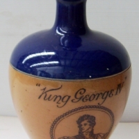 Royal Doulton KING GEORGE IV Old Scotch Whisky FLASK with blue glazed shoulder & stopper, glazed stoneware with picture & text - Sold for $110 - 2008
