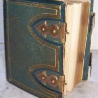 Small Victorian leather bound PHOTO ALBUM with brass fittings complete with portrait photos - Sold for $85 - 2014