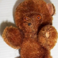 Brown mohair mini BEAR, pin jointed arms & legs, pink felt inner ears, small red paper tag pinned to back Germany East - 10cms long - Sold for $61 - 2014