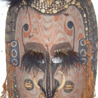 Large Carved Wooden PNG Sepik TRIBAL WALL MASK with Woven Cane Rim, Feather, Shell Embedded in Resin, Boar Tusk and Ochre Decoration, L93cm - Sold for $98 - 2008