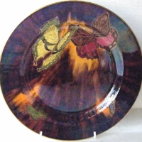 Wilkinson Ltd.  ART DECO LUSTRE cabinet plate, pretty coloured butterflies with gilt detailing on a plum & orange ground Approx 27 cm D - Sold for $73 - 2009
