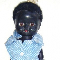 1950's black plastic DOLL, made in ENGLAND  Swings head from side to side when walked, sleep eyes, curly wool hair Approx 30cm H - Sold for $110 - 2009