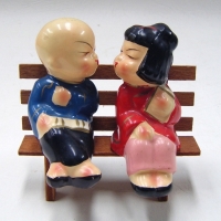 Pair vintage porcelain ORIENTAL Salt & Pepper Shakers - Boy & girl KISSING on wooden bench - Sold for $67 - 2009