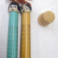 3 items - 2 x vintage novelty plastic cylinder shaped NEEDLE Holders, with heads & hair & cream Thimble - Sold for $55 - 2009