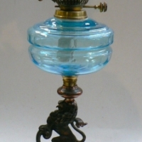 Tall Victorian style twin burner OIL LAMP with light pink etched shade, blue cut glass Bowl, base features Standing lion on cast iron base - 75cm high - Sold for $183 - 2014