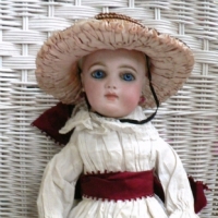 French c1880's closed mouth BRU JNE Bebe bisque DOLL, kid body, blue glass eyes, bisque hands, forearms, orig pierced earrings, clothing, straw ha - Sold for $7442 - 2014