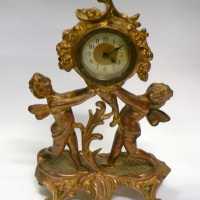 Vintage ornate gilt metal CLOCK featuring CHERUBS with wind-up German movement - 24cm high - Sold for $104 - 2014