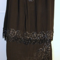 1920's black silk chiffon two piece evening outfit with under petticoat forming skirt & over blouse both with beaded motifs & black beaded fringing (S - Sold for $220 - 2014